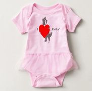 The design on this baby bodysuit with tutu is inspired by the book series, "Rattles, the Barn Cat."