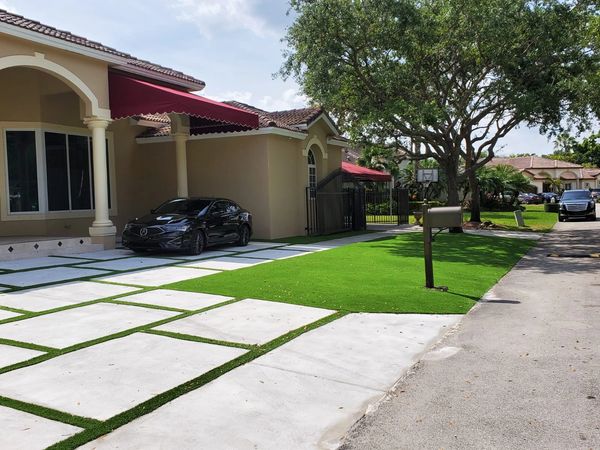 Synthetic grass strips between concrete slabs Miami