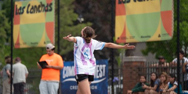 Athlete celebrating on a field during a sports event.