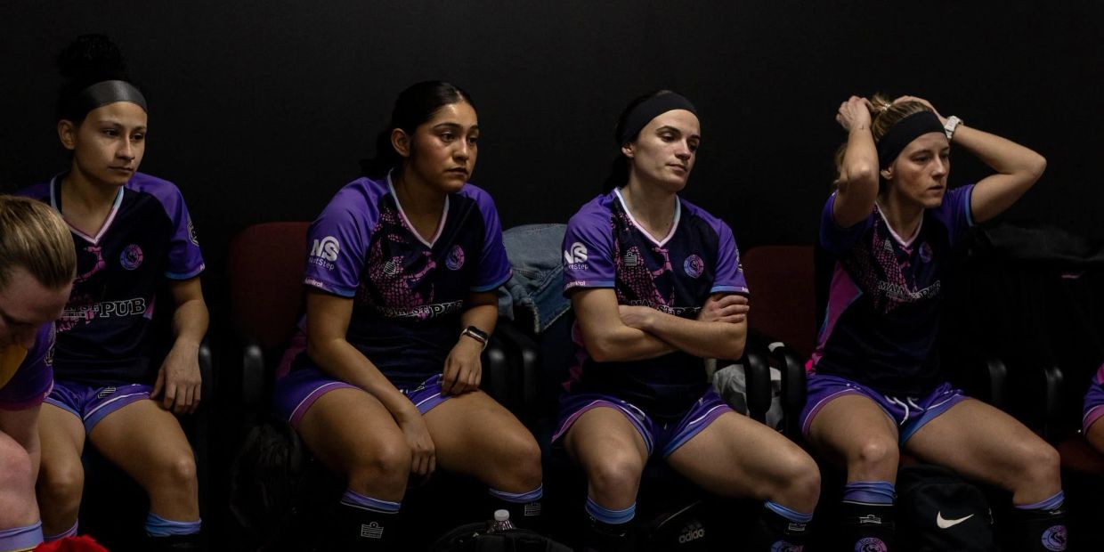 Women soccer players resting in a locker room.