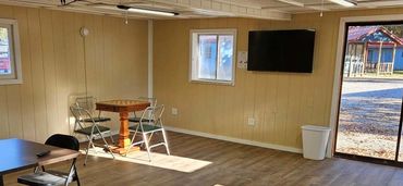 remodeled game room with a tv.