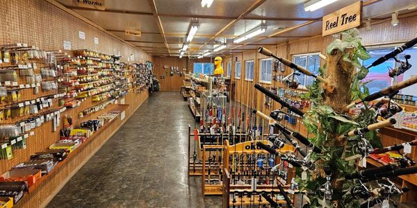 Inside of the tackle shop. Displays of rods, reels, and lures.