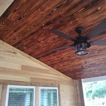 Rough cut cypress lap siding and burnt wood finished tongue and grooved ceiling