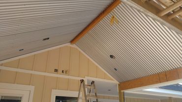 Outdoor grilling area with a corrugated metal ceiling!