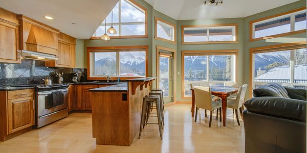 Cozy kitchen and dining area with mountain views throughout the whole property. Canmore vacation homes at its finest.