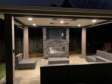 Outdoor living cover with fireplace, heaters and tv