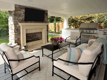 Outdoor living space with fire place, TV and Kitchen