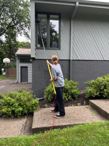 One of our employees using a Water Fed pole to clean a Residential Window