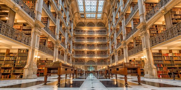 A huge library with many levels represents market research and benchmarking services