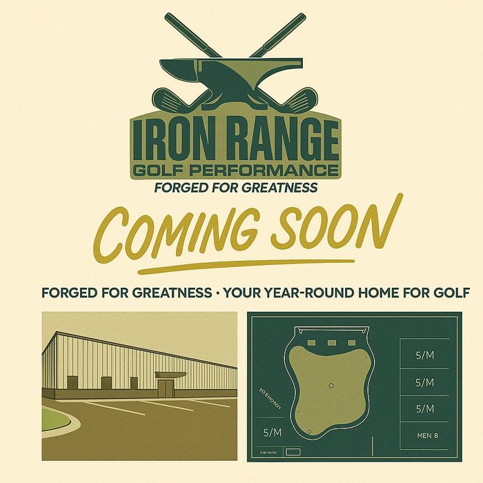 Two people in a formal setting reviewing documents at a wooden table.