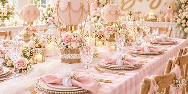 Elegant pink-themed party table setup with floral decorations.
