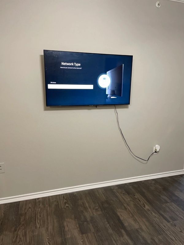 50 inch flatscreen television mounted onto wall.