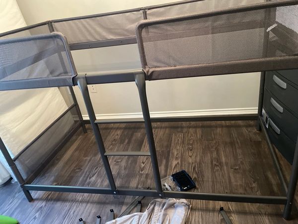 Metal twin children's bunkbed with fabric rails.