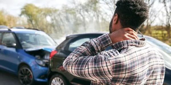 Man grabbing neck from auto accident