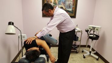 A person massaging a boy