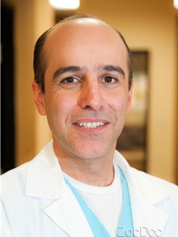 Smiling doctor in white coat indoors.