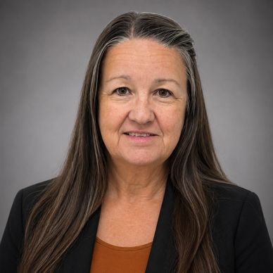 Professional portrait of a middle-aged woman with long hair and a warm smile.