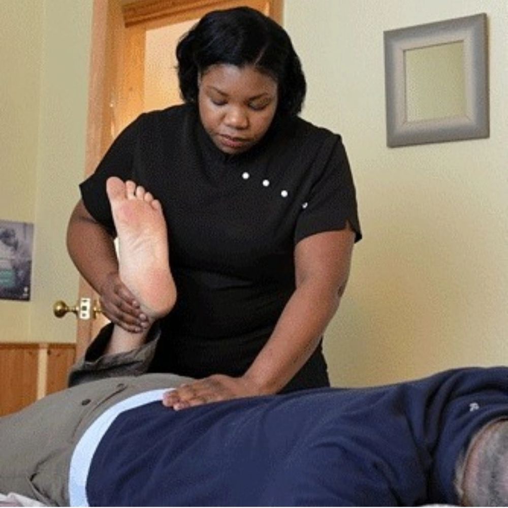 Keon Williams Certified Massage Specialist, with a client offering massage to the back area