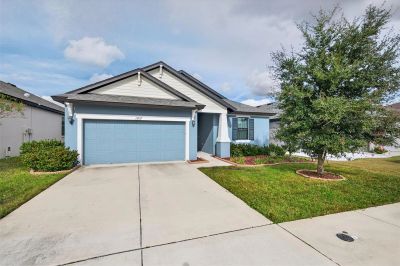 Single-story house with blue garage door and front yard.
