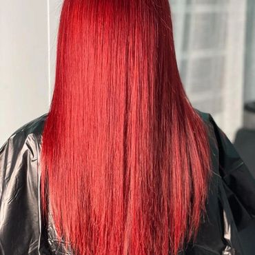 Vibrant red long straight hair with a glossy finish.