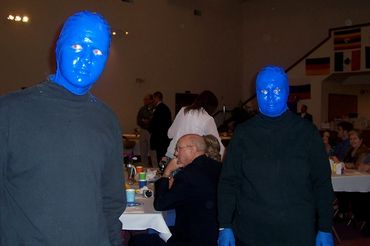 2 blue men at the wedding reception staring at camera