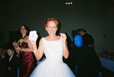 bride poses with a take out box and blue man group