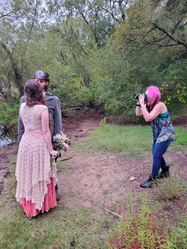 Pink Hair Jen photographing an elopement behind the scenes in the forest