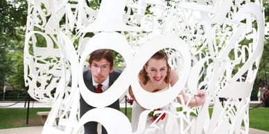 Eric and Mandy posing at an art sculpture on the MIT campus in Cambridge Massachusetts