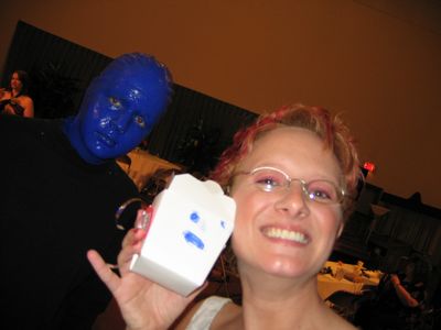 blue man fan bride poses with a blue man and a to go box