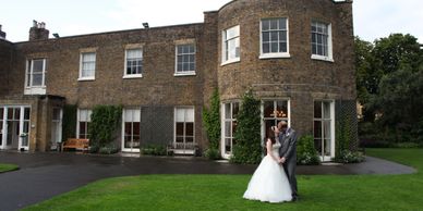 Couple kissing outside the main building of the Kew Gardens in London United Kingdom