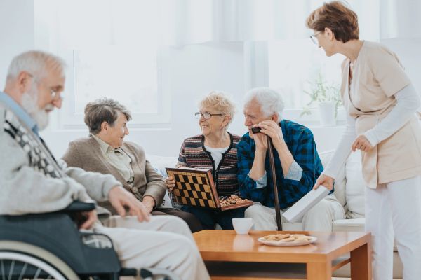 Elderly people playing chess in a cozy room.