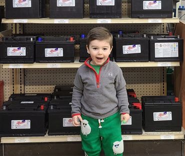 Child in front of batteries