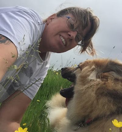 Ange with a german shepherd in a country setting