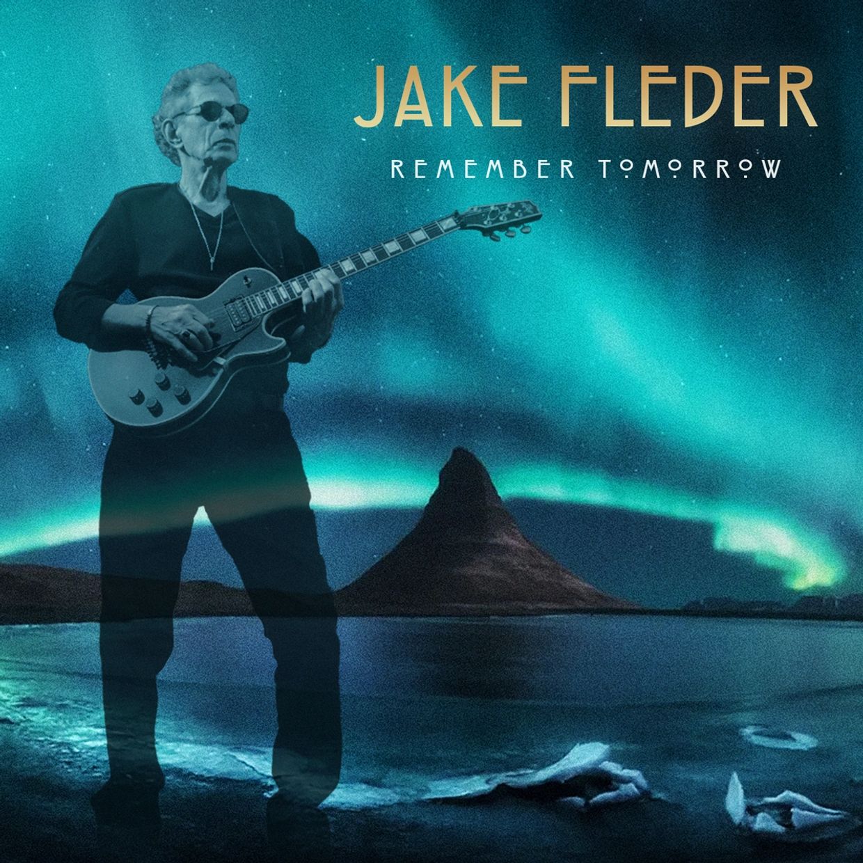 Jake Fleder playing guitar under northern lights.