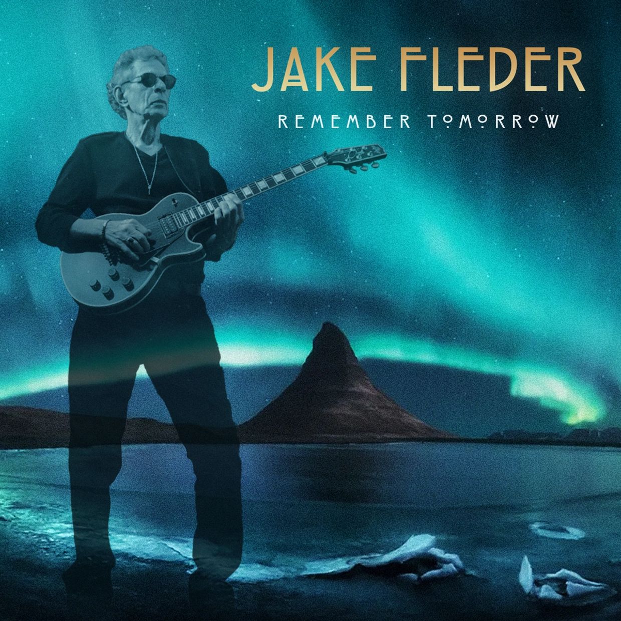 Jake Fleder playing guitar under northern lights.