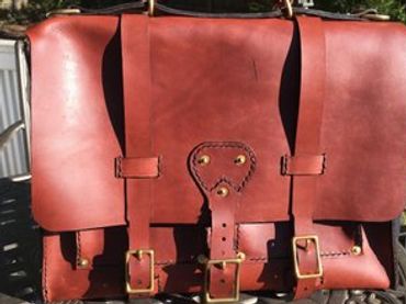 Lady's leather messenger bag, Custom  leather bags in Raleigh, NC. Comes with adjustable strap.