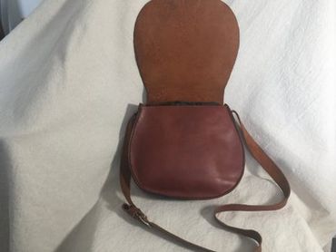 Ladies leather horse shoe crossbody bag with adjustable shoulder strap.