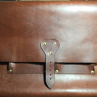 Leather messenger bag with brass saddle rivets, handmade in Raleigh, NC.