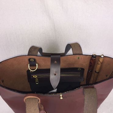 Two tone Brown leather tote with dark bown leather bottom with shoulder straps and leather tassel.