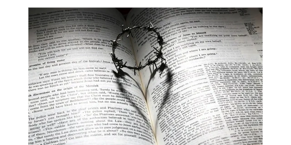 Symbolic photo of scripture and crown of thorns with a heart-shaped shadow of grace and redemptio