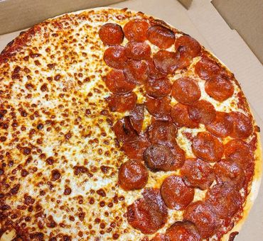 Half pepperoni, half cheese pizza in a box.