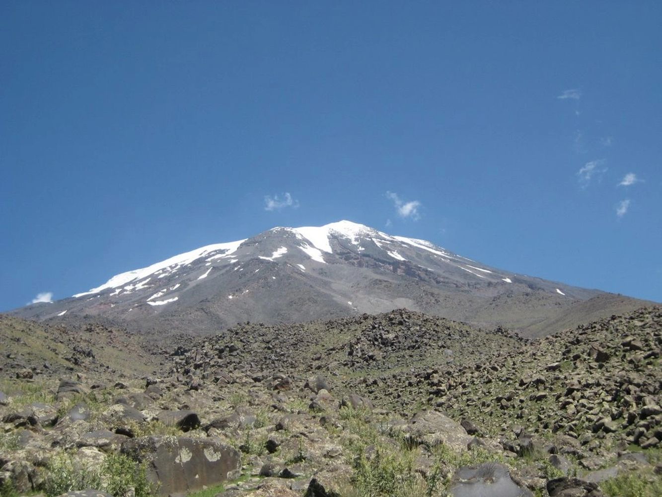 Snow-capped mountain under a clear blue sky.