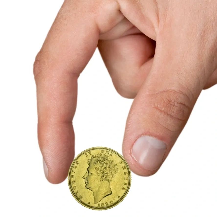 Gold Coin Being Held in Hand