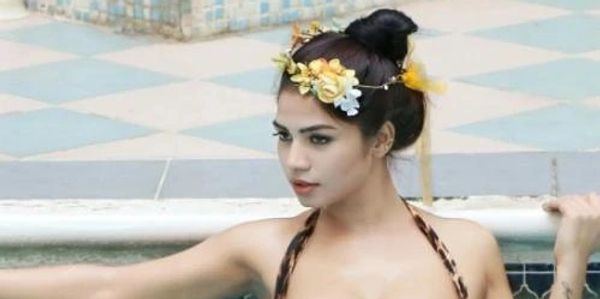 Woman wearing floral headband at poolside.