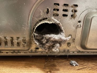 A dryer vent clogged with lint.