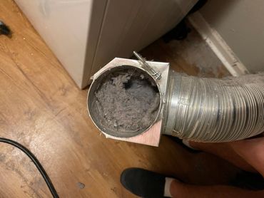 A dryer vent hose clogged with lint.