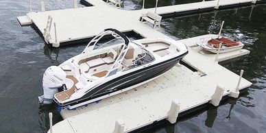 two side by side jet ski ports with red and blue wheels for storing wave runners next to dock