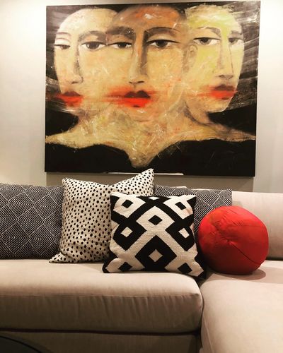 A painting by David Harouni hangs above the sofa.