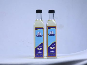 Two bottles of coconut oil with blue and yellow labels on a plain background.