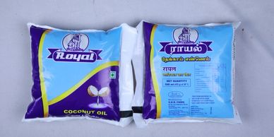 Two packets of Royal brand coconut oil with English and Tamil labels.